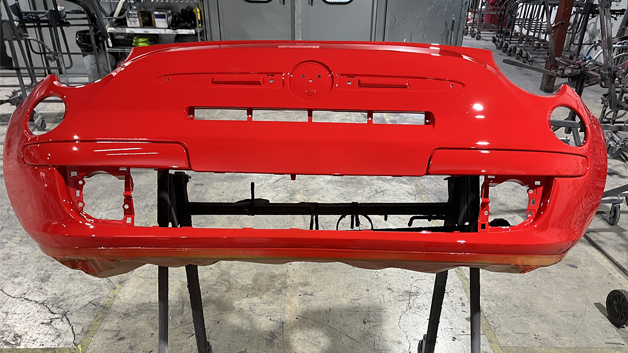 Partify painted red and unfolded bumper cover ready to be shipped