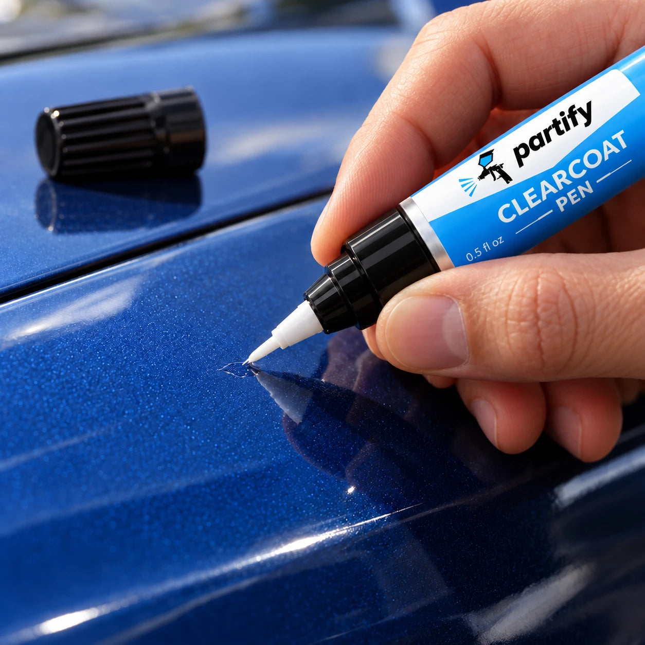 Applying clearcoat from the light-blue-labeled Partify pen