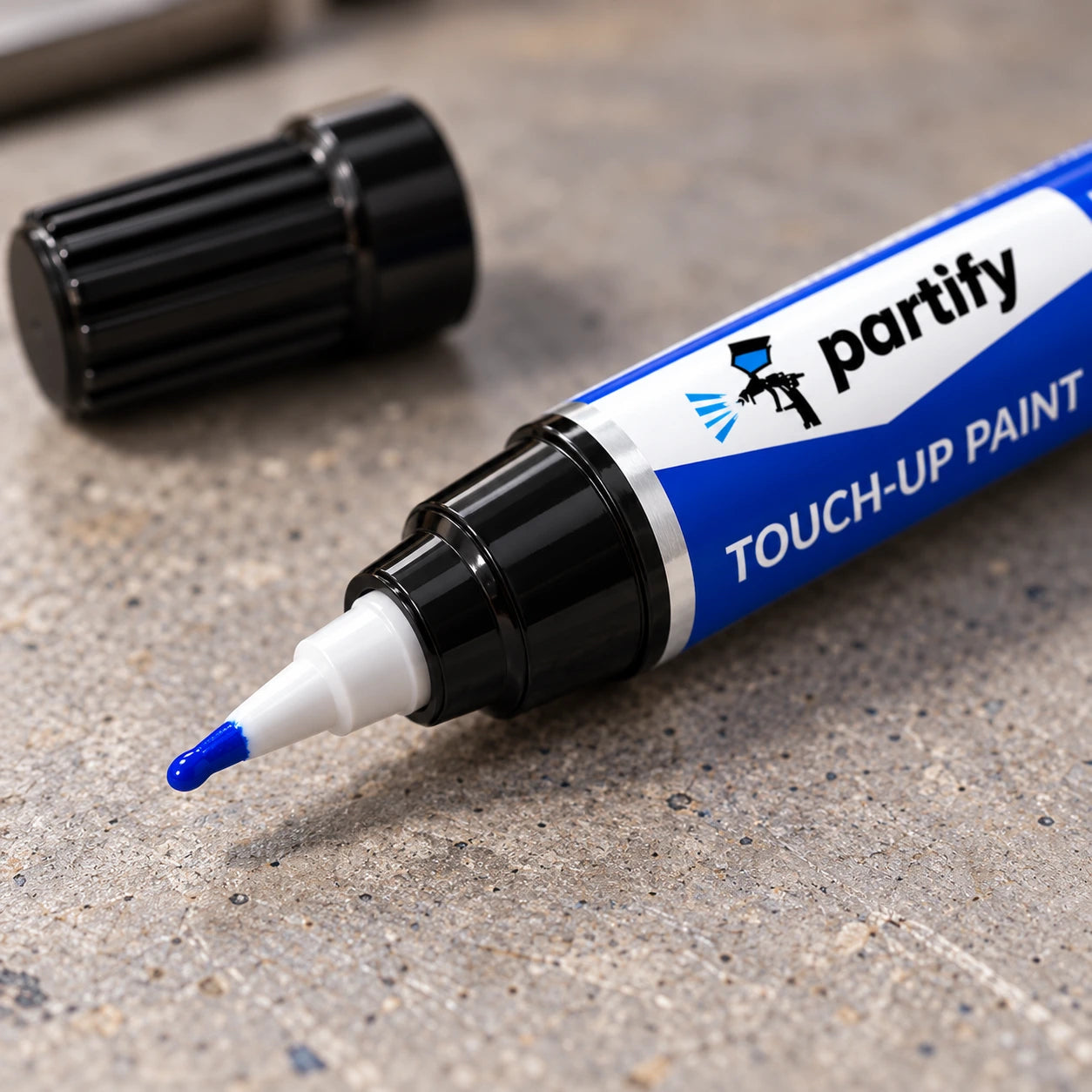 Close view of the current Partify pen's small precision nib with its black cap set aside