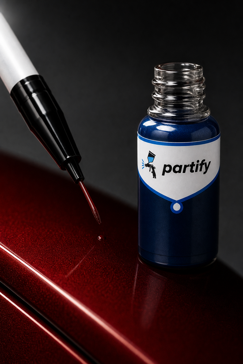 Partify touch-up paint bottle and fine precision brush over a metallic red car panel